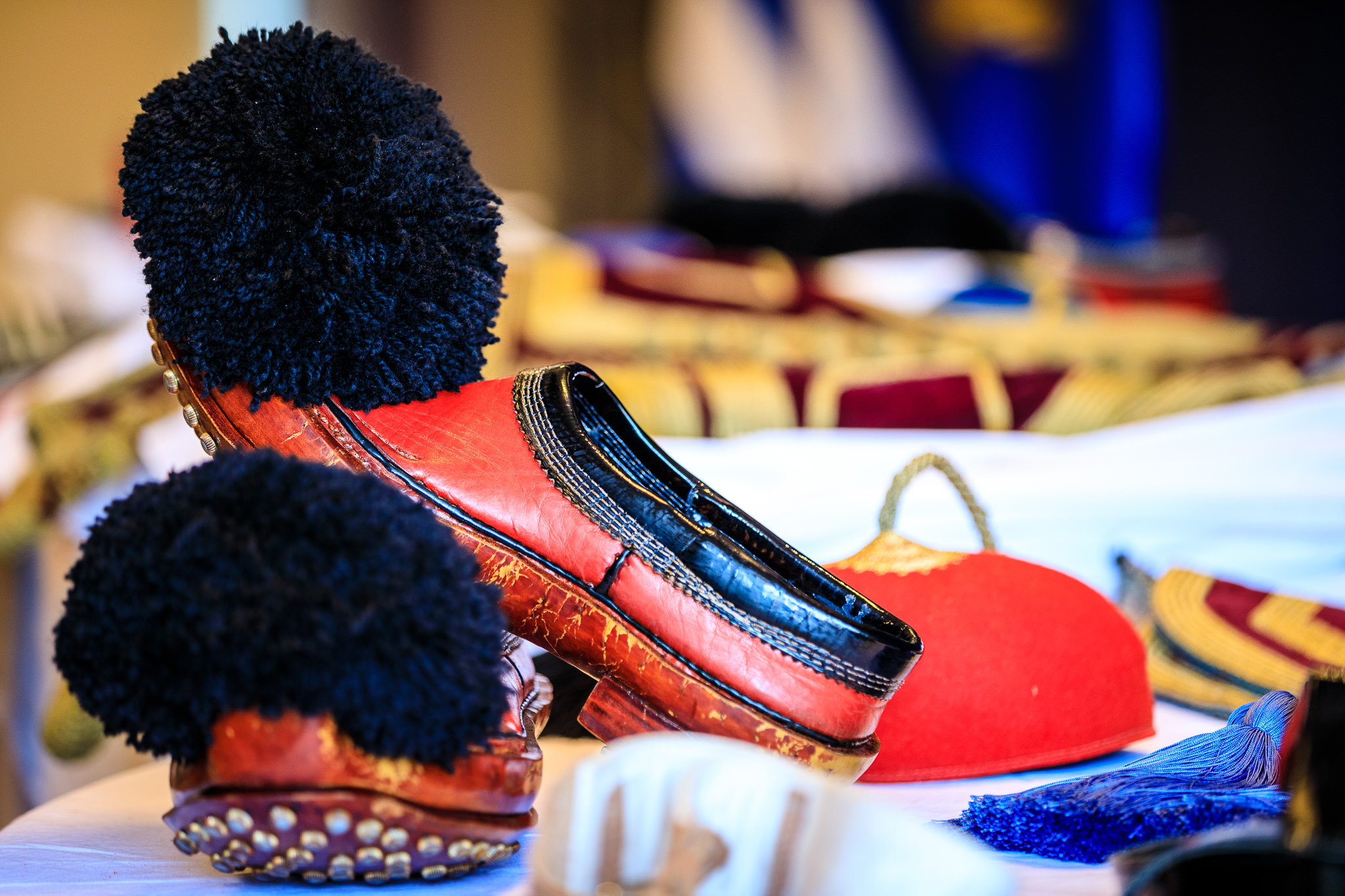TheEvzonesCollection 79 – The Evzones Collection Close-up of an Evzone's red tsarouchia with black pom-pom and the pleats of the white fustanella – Greek Presidential Guard